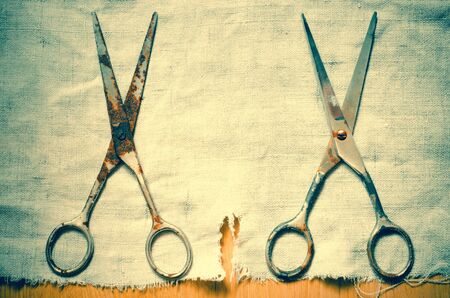 two old scissors on a canvas backgroundの写真素材