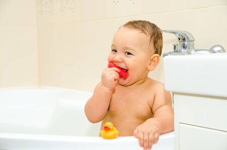 baby boy swimming in a bathroom