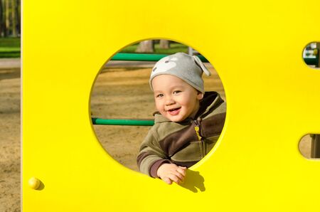 little boy playing at the playground outdoorsの写真素材