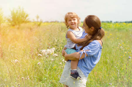 mother and child on the sunny meadowの写真素材
