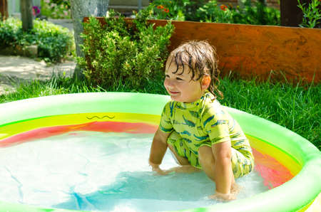 little boy in swimming pool outdoorsの写真素材
