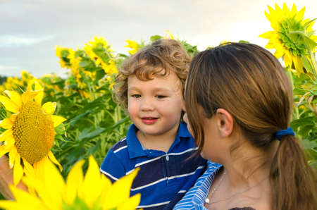 mother and baby in sunflowers fieldの写真素材