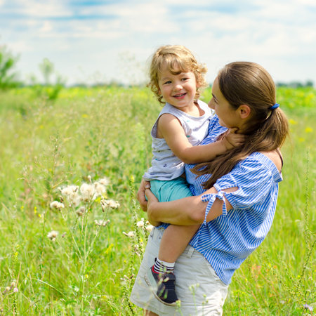 mother and child on the sunny meadowの写真素材