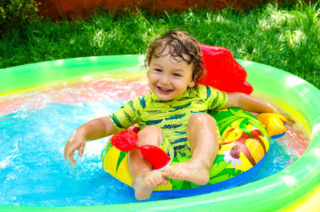 little boy in swimming pool outdoorsの写真素材