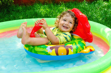 little boy in swimming pool outdoorsの写真素材