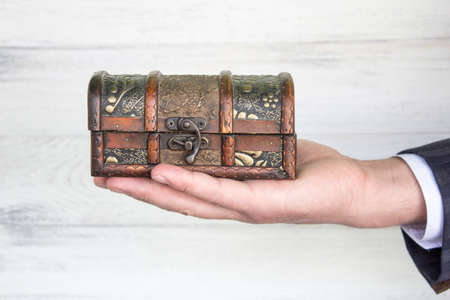 antique chest (antiques) in the hand of a businessman.の写真素材
