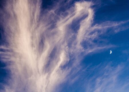 Beautiful blue sky with white clouds and moon
