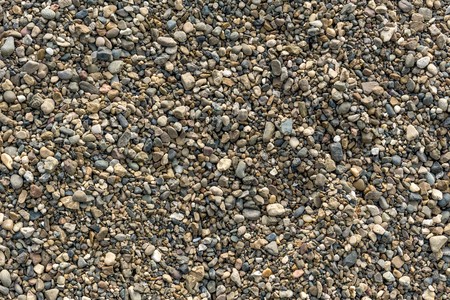 Abstract natural background with dry round pebble stone uneven surface. Gravel texture.の写真素材
