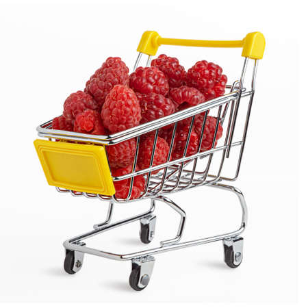 Fresh tasty raspberry in the shopping cart. Creative organic food concept. Bold vivid colors. Isolated on white. Clipping path.の写真素材