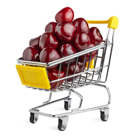 Fresh delicious, tasty cherry in the shopping cart. Bold vivid colors. Creative organic food concept. Isolated on white. Clipping path.の写真素材