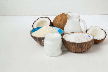 Set of coconut products, butter, milk, flour, chips, on a white background