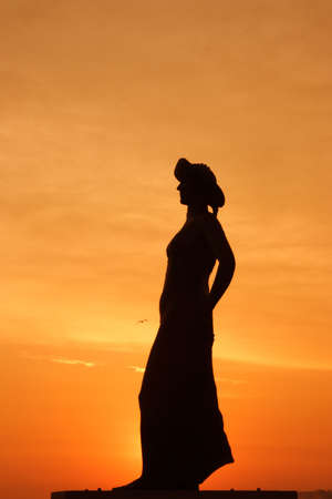 Female profile against the background of sunrise.の写真素材