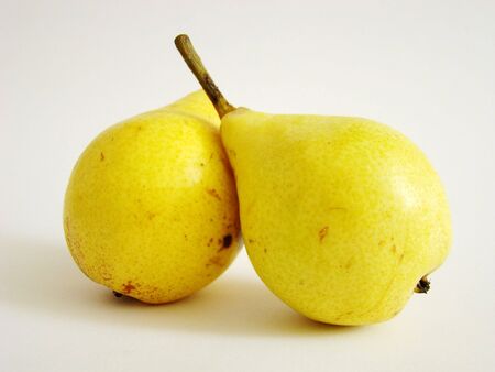 ripe yellow pear lying on a white backgroundの写真素材