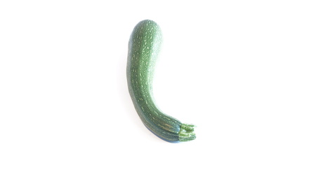 Green zucchini lays on a white backgroundの写真素材