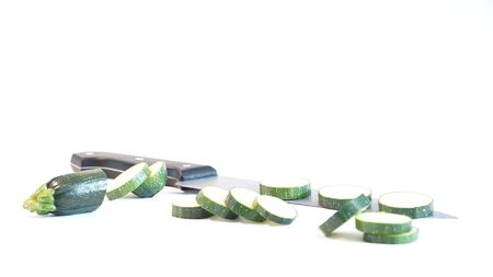 Fresh green zucchini cut knife are isolated on a white backgroundの写真素材