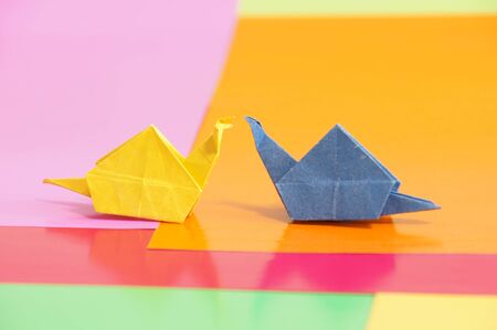 Paper origami snail isolated on a colorful backgroundの写真素材