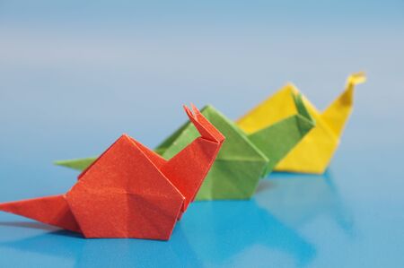 Paper origami snail isolated on a colorful backgroundの写真素材