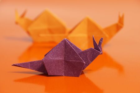 Paper origami snail isolated on a colorful backgroundの写真素材