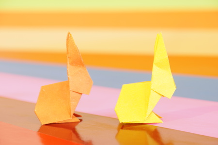 Paper origami rabbit isolated on a colorful backgroundの写真素材