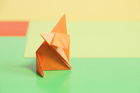 Paper origami fox isolated on a colorful backgroundの写真素材