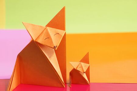 Paper origami fox isolated on a colorful backgroundの写真素材