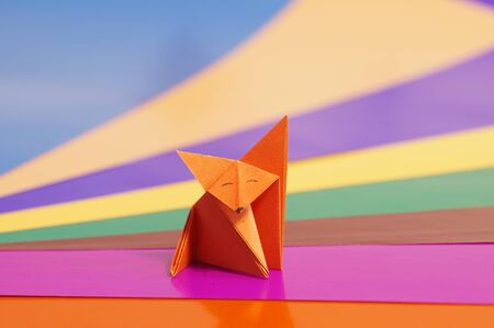 Paper origami fox isolated on a colorful backgroundの写真素材