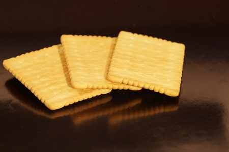 Sweet crackers are isolated on a black backgroundの写真素材