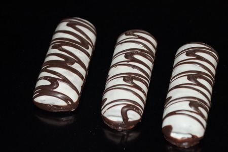 Chocolate cake on a black background in large quantities