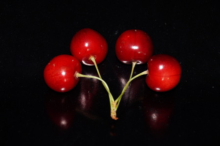 Red ripe cherries isolated on a bright background