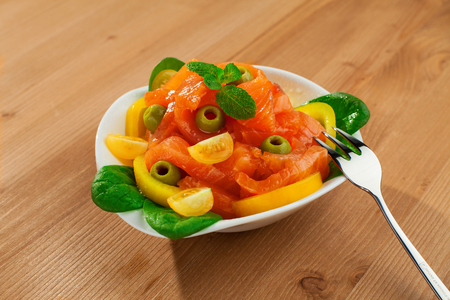 fresh red fish salad fish composition  wood tableの写真素材
