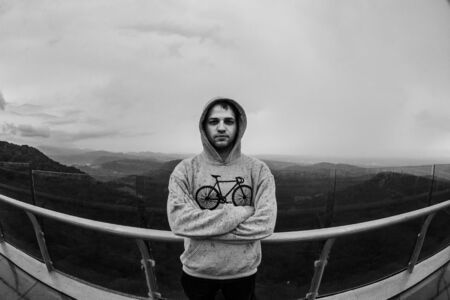 Man standing on a rock of mountain. Lifestyle, outdoor activities, moods and emotions concept.の写真素材