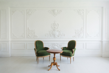 portrait of vintage vanity table set with stool over wall design bas-relief stucco mouldings roccoco elements.の写真素材