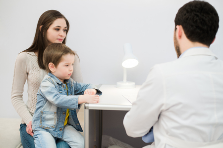 Little boy with mum on control pediatric visitの写真素材