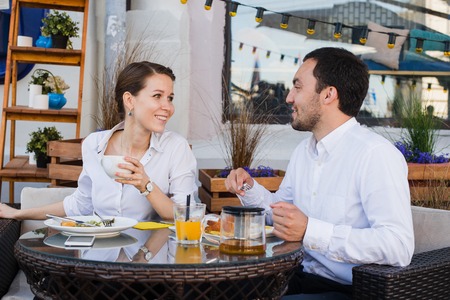 Happy business people on their lunch outside at the coffee shop.の写真素材