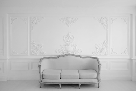 Antique white sofa fretwork wall on backroundの写真素材