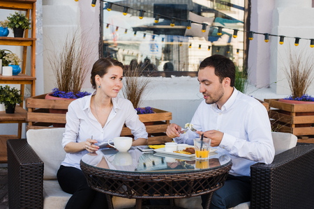 Happy business people on their lunch outside at the coffee shop.の写真素材
