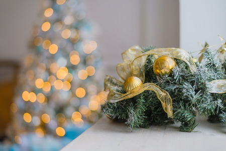 Gold Christmas background of de-focused lights with decorated treeの写真素材