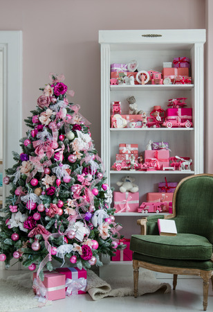 Interior room decorated in Christmas style. No people. An empty chair. Neutral colors. Home comfort of modern homeの写真素材