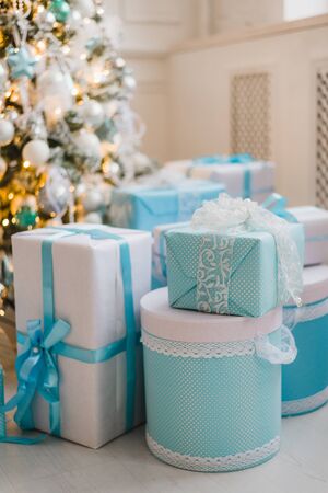 Christmas gifts under the Christmas tree in blueの写真素材