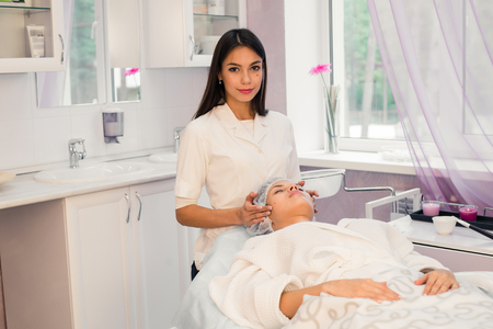 Woman cosmetologist to work in beauty salon.の写真素材