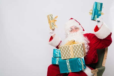Santa Claus Christmas. Santa holding many Christmas gifts.の写真素材