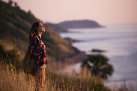 Summer sunny lifestyle fashion portrait of young stylish hipster woman walking in mountains, wearing...