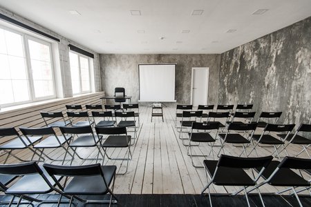 Empty modern classroom with black chairs projector screenの写真素材