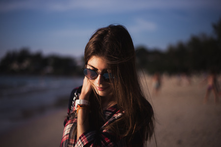 young stylish happy hipster woman traveling around the world wearing aviator sunglasses, denim shirt, tropical island lagoon vacationの写真素材