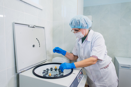 Platelet-Rich plasma preparation. Tube with blood in hands. Centrifuge. Backgroundの写真素材