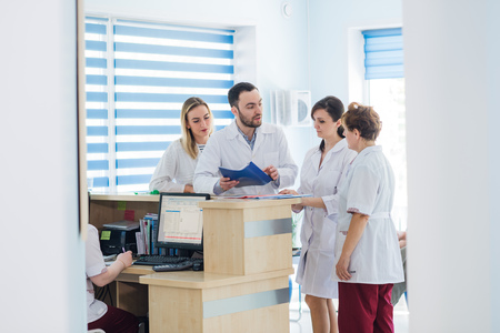 Doctor and receptionist at reception in a hospitalの写真素材