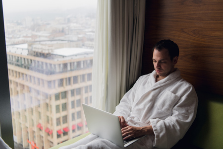 Young man freelancer working from home on a laptopの写真素材