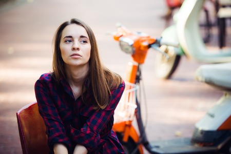 Portrait of pretty smiling girl on scooter