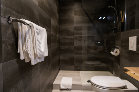 white towel on a hanger prepared to use in bathroom.