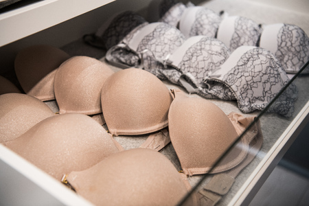 Feminine lacy underwear stored in cases in a wardrobeの写真素材